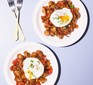 Two plates of mushroom potato hash with poached eggs on top
