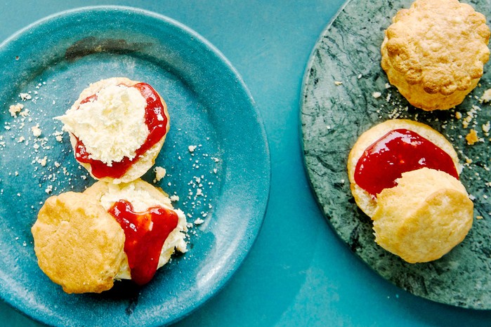 Air fryer scones topped with cream and strawberry jam