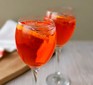 Aperol spritz cocktail in glass with orange