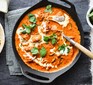 Butter chicken in pan with spoon