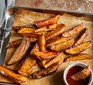 Paprika potato wedges on a tray with dipping sauce