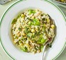 Courgette & broad bean risotto with basil pesto served in a white bowl