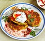Courgette & ricotta fritters with poached eggs & harissa yogurt served on a plate