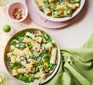 Two bowls of creamy spring greens rigatoni with lemon, bacon & chilli