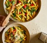 Fridge-raid one-pan pesto pasta in a saucepan and bowl