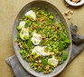 Lemony broad beans with goat's cheese, peas & mint in a large dish