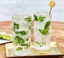 two glasses of mojito cocktail with stirrer