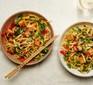 Two bowls of noodles with crispy tofu with peas