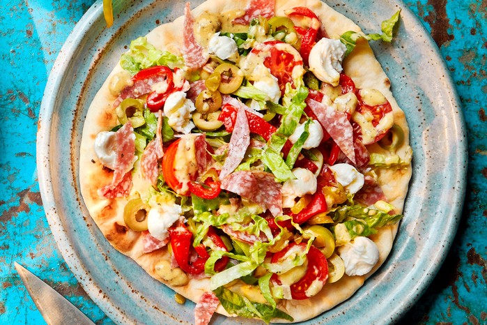 Pizza salad flatbreads topped with salami, picked peppers and cheese