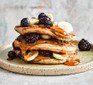 Protein pancakes served with maple syrup and fruit