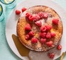 Raspberry cake decorated with fresh raspberries and icing sugar