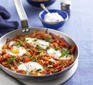 Menemen made with eggs and peppers in a silver frying pan