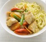 Bowl of lemon chicken chunks with vegetables and noodles