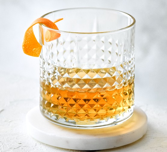 Sazerac in a glass with orange peel garnish