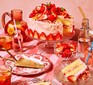 Strawberry lemonade cake on a cake stand with a slice cut out