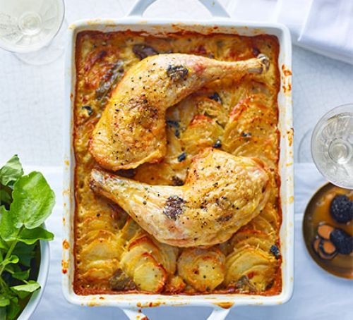 Rectangular dish with two chicken legs and potato gratin